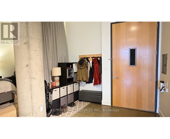 A bedroom with a bed, nightstand, and closet.