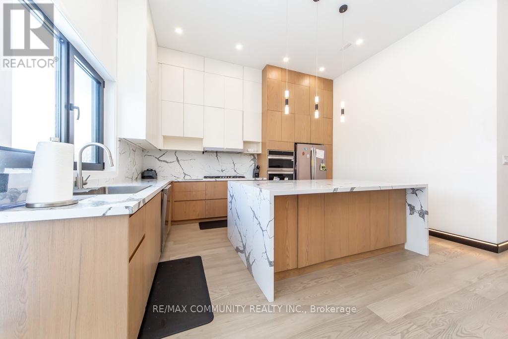 A modern kitchen with wooden cabinets and a marble countertop.