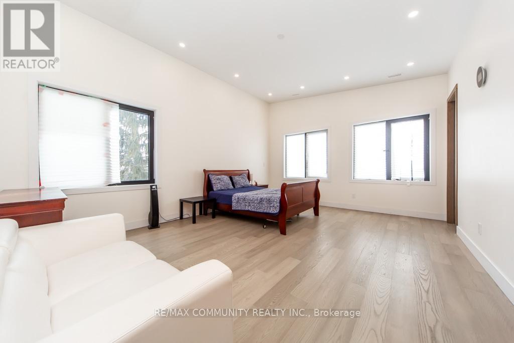 A bedroom with a bed, a couch, and a table.