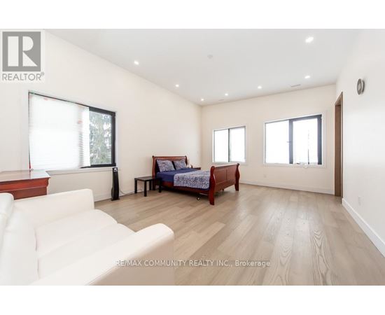 A bedroom with a bed, a couch, and a table.