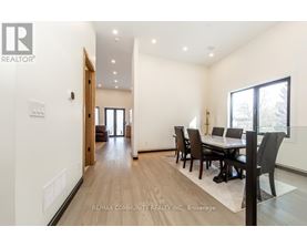 A dining room with a table set for four.
