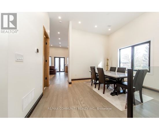 A dining room with a table set for four.