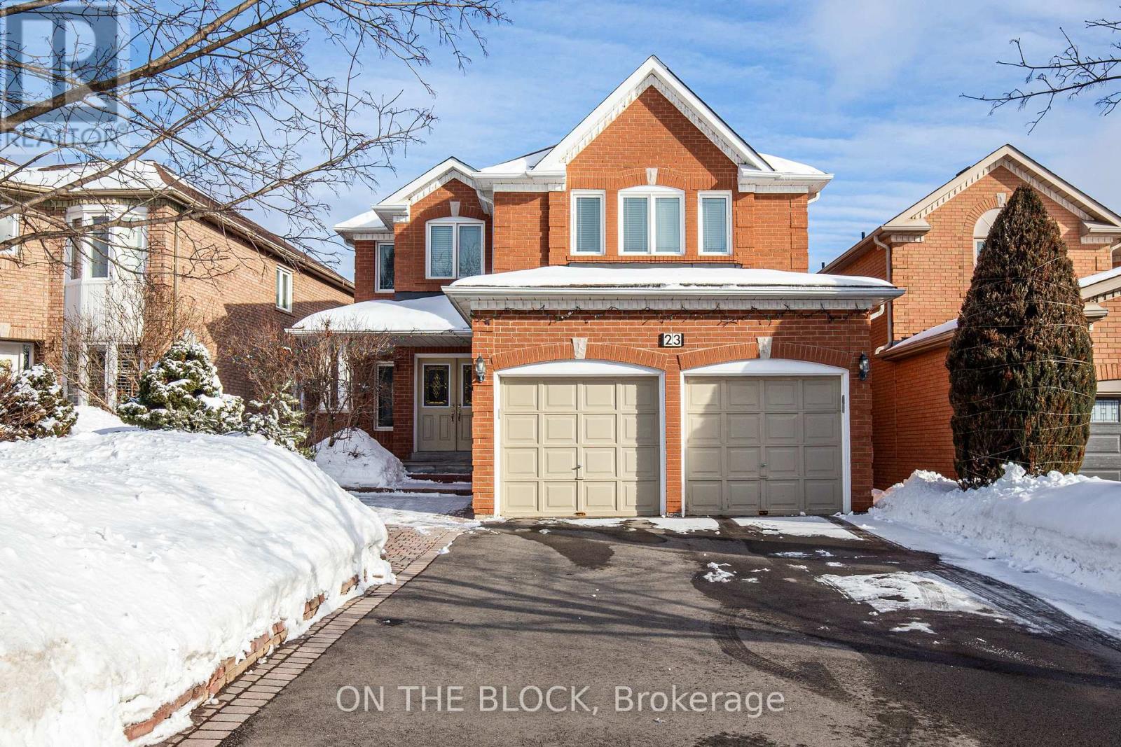 A house with a snow-covered driveway and the text "ON THE BLOCK, Brokerage."