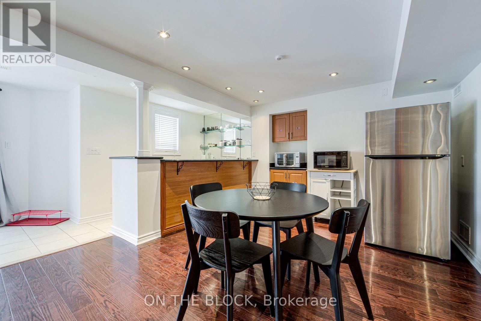 A modern kitchen with a dining table and chairs.