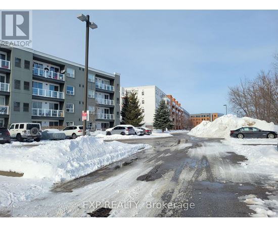 A snowy street with cars parked on the side.