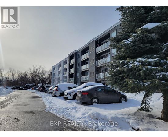 A car is parked in front of a building with snow on the ground.