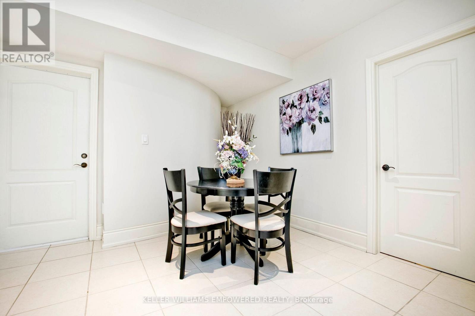 A dining room with a table set for four.
