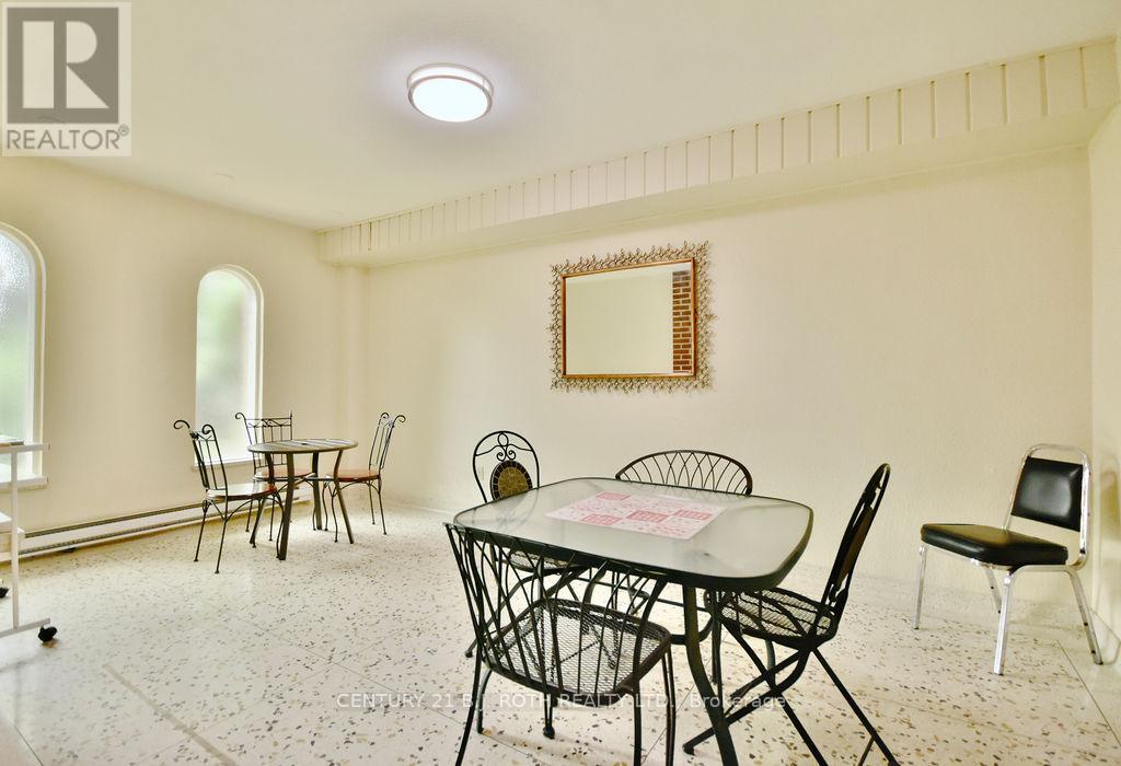 A dining room with a table set for four.