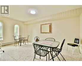 A dining room with a table set for four.