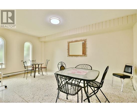 A dining room with a table set for four.