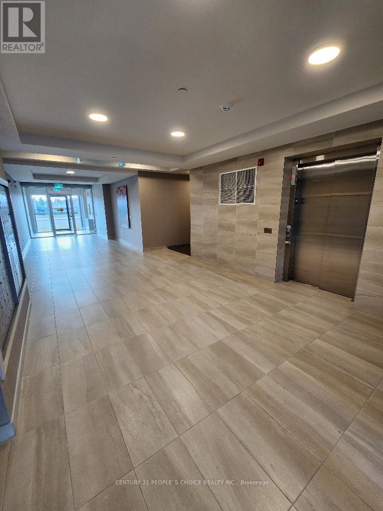 A hallway with tiled floors and a sign that says "REALTOR".