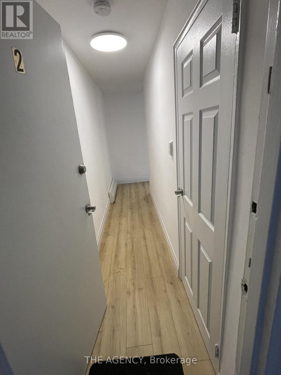 A hallway with a door on the right and a sign on the wall that says "REALTOR".