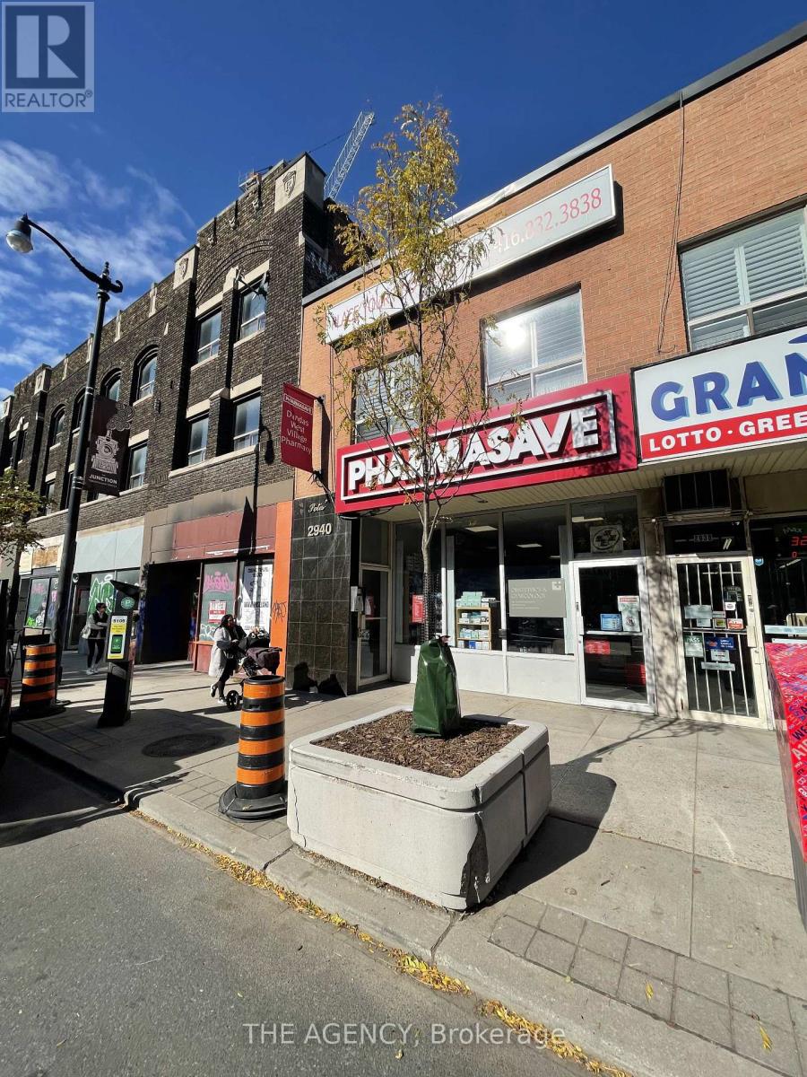 A street view of a city with a building that has a sign that says "Phasave".