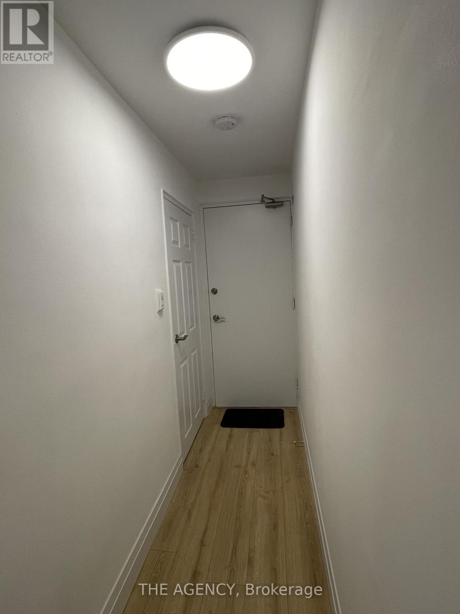 A hallway with a door at the end.