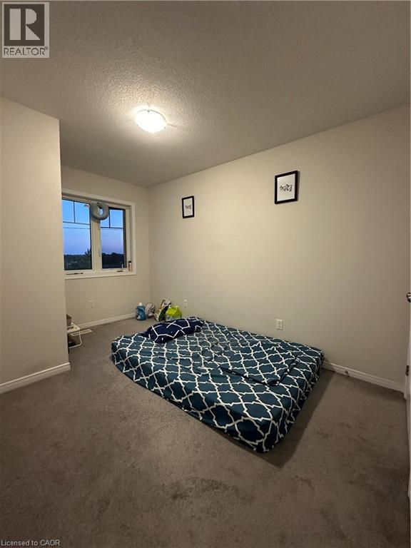 A bedroom with a bed and a window.