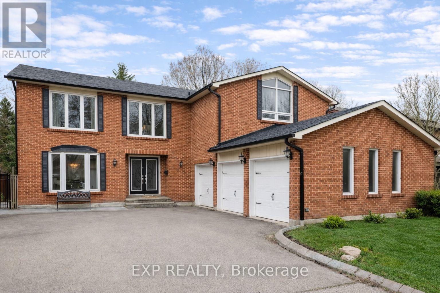 A large brick house with a garage is for sale.