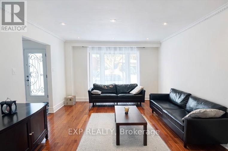 A living room with a black couch and a coffee table.