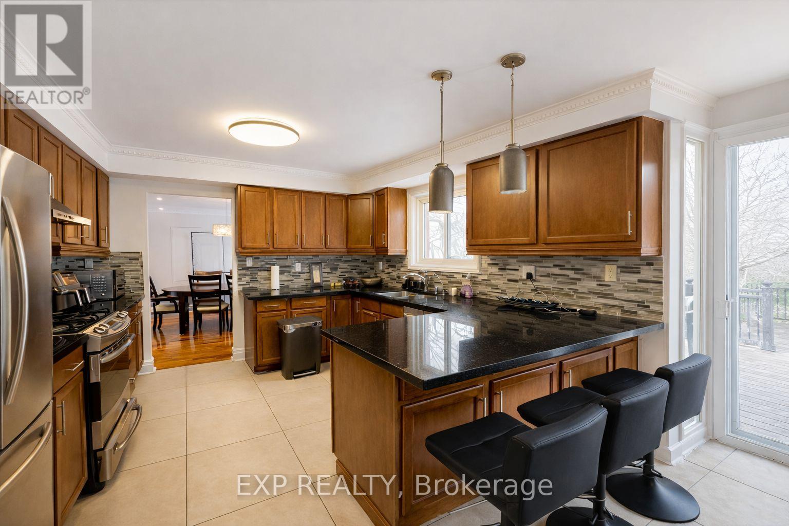 A kitchen with wooden cabinets and a black countertop.