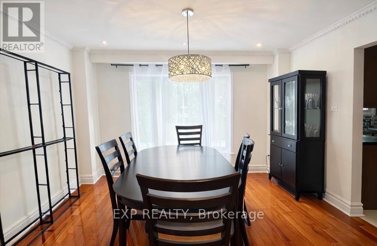 A dining room with a table set for four.