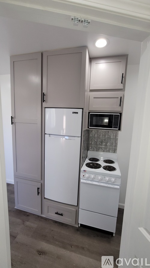A kitchen with a white fridge and stove.