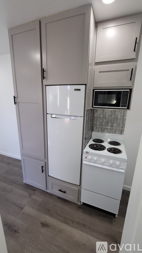 A kitchen with a white fridge and stove.