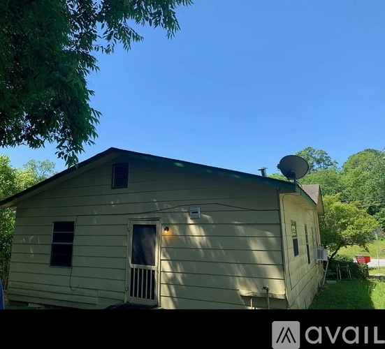 A small house with a satellite dish on the roof.