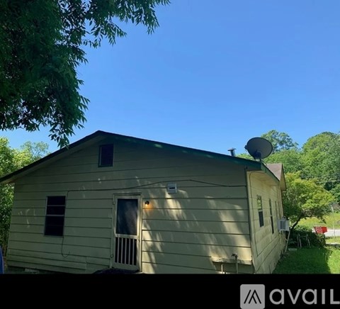 A small house with a satellite dish on the roof.