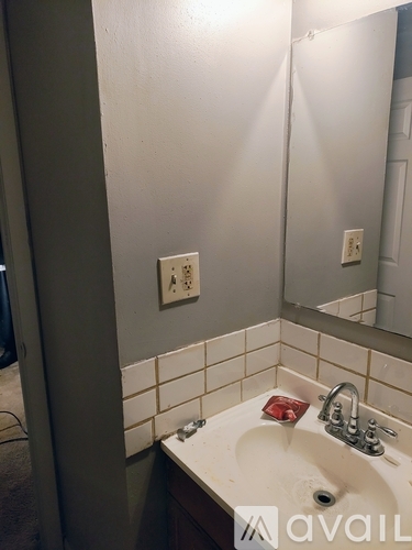 A bathroom with a sink and a mirror.