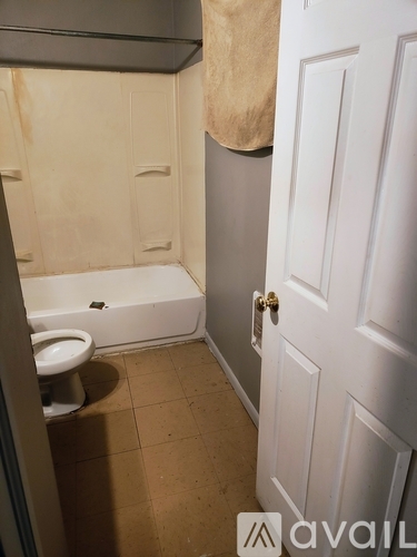 A bathroom with a toilet and a door.