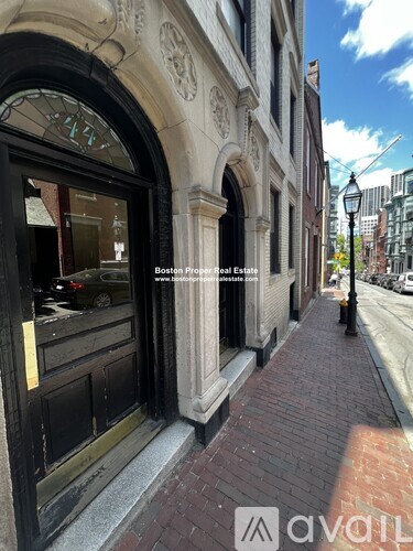 A street view of a building with a window and a door.