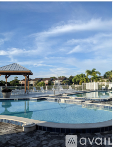 A pool with a hot tub and a gazebo.