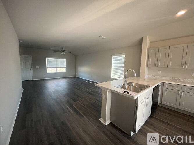 A kitchen with a sink and cabinets is available for rent.