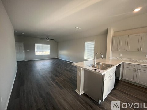 A kitchen with a sink and cabinets is available for rent.