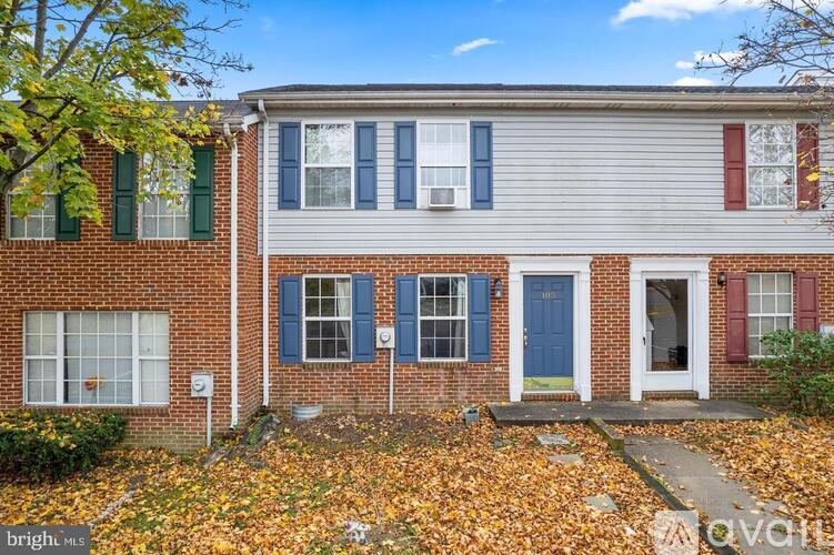 A house with a blue door and red shutters is for sale.
