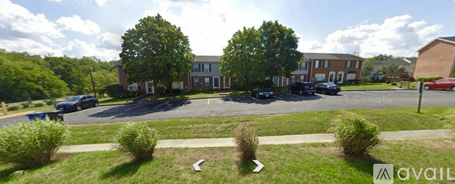 A parking lot in front of a building with a sign that says "available".