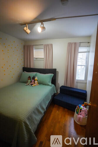 A bedroom with a bed and a bench.