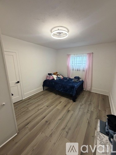 A bedroom with a dressing table and a mirror with lights.