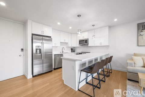 A modern kitchen with white cabinets and a central island.