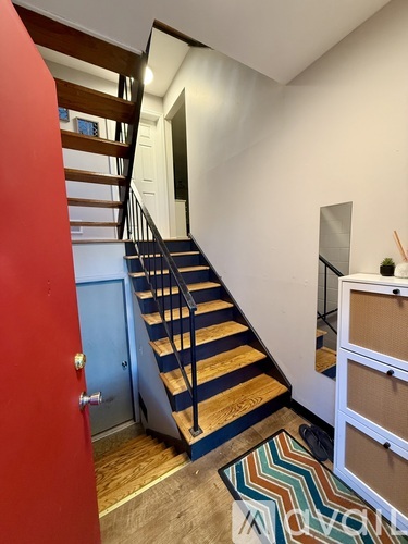 A staircase with a blue railing and wooden steps.