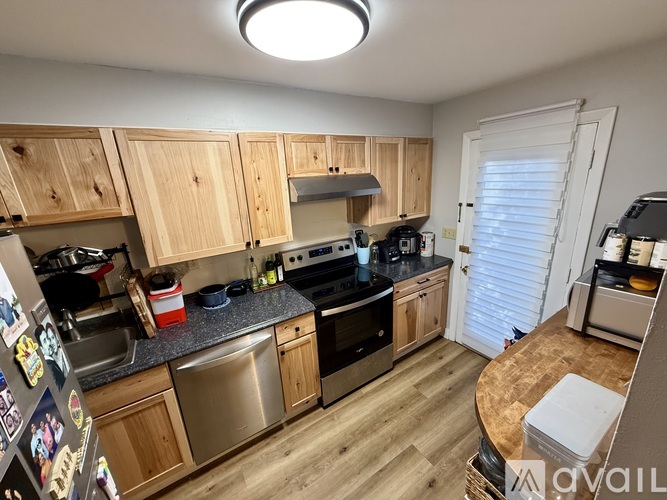 A kitchen with wooden cabinets and stainless steel appliances.