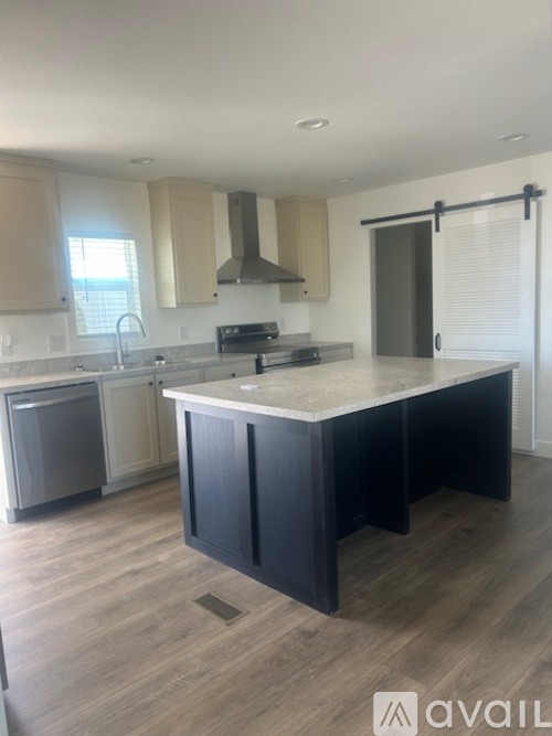 A kitchen with a large island in the middle.