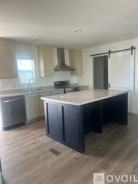 A kitchen with a large island in the middle.