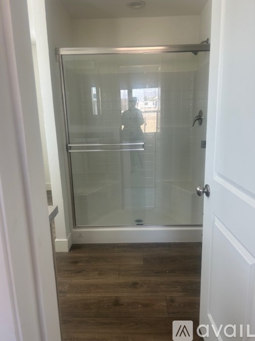 A person is standing in a glass door.