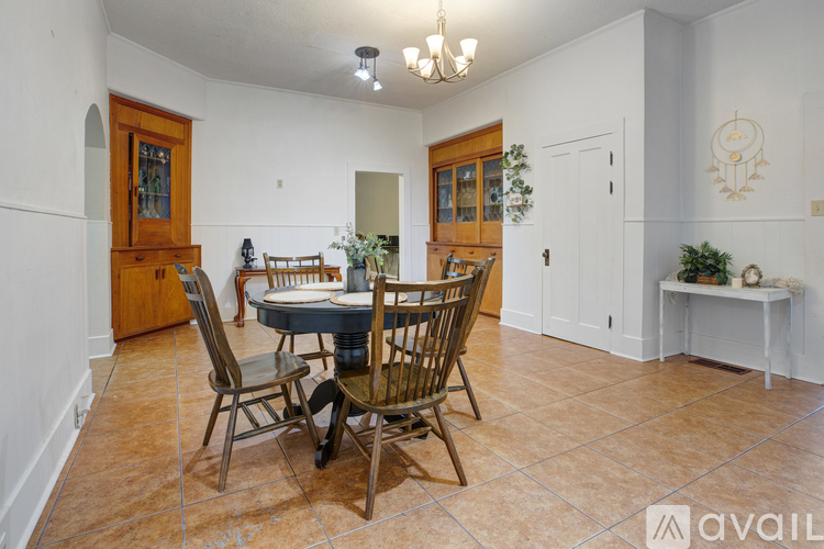 A dining room with a table set for four.