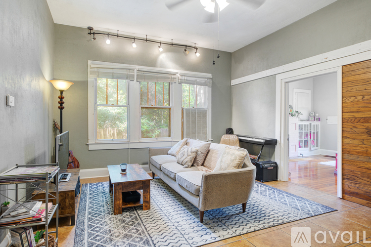 A living room with a couch, a coffee table, and a television.