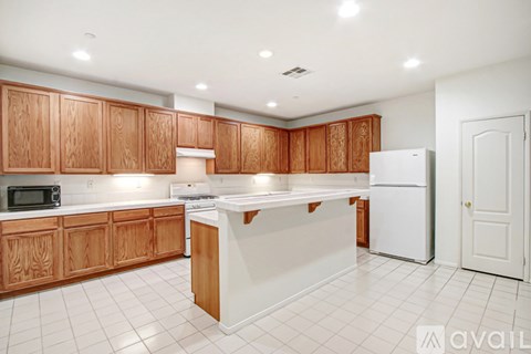 A kitchen with wooden cabinets and white appliances.