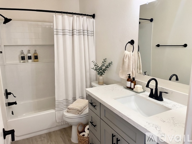 A spacious room with a ceiling fan and a door leading to another room.