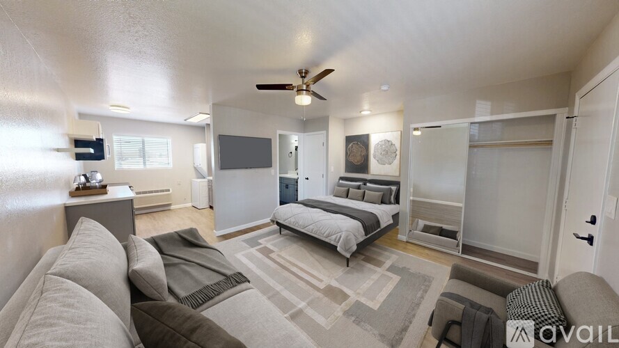 A spacious bedroom with a large bed and a couch.