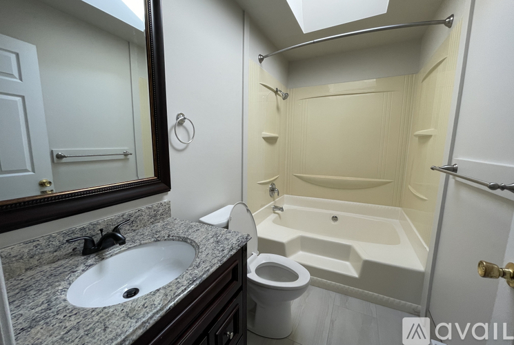 A bathroom with a sink, toilet, and bathtub.