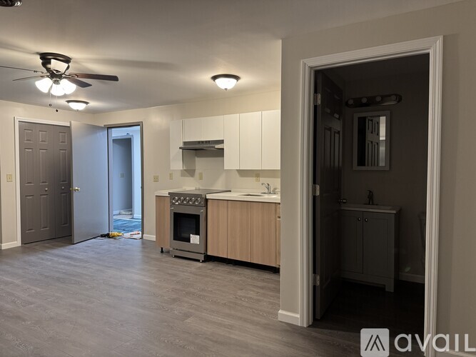 A modern kitchen with a grey floor and white walls.